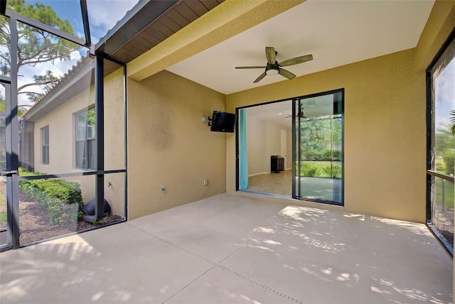 unfurnished sunroom featuring ceiling fan