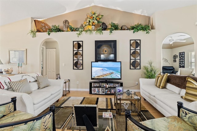 living room featuring hardwood / wood-style flooring, high vaulted ceiling, and ceiling fan