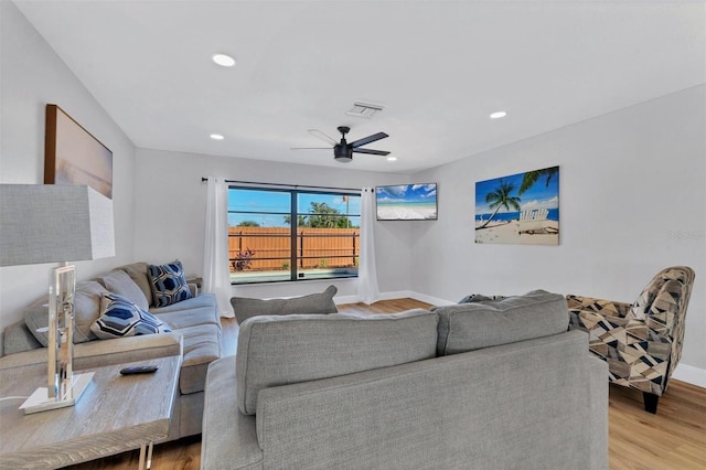 living room with ceiling fan and light hardwood / wood-style flooring