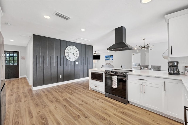 kitchen featuring extractor fan, light hardwood / wood-style flooring, a notable chandelier, white cabinetry, and stainless steel electric range