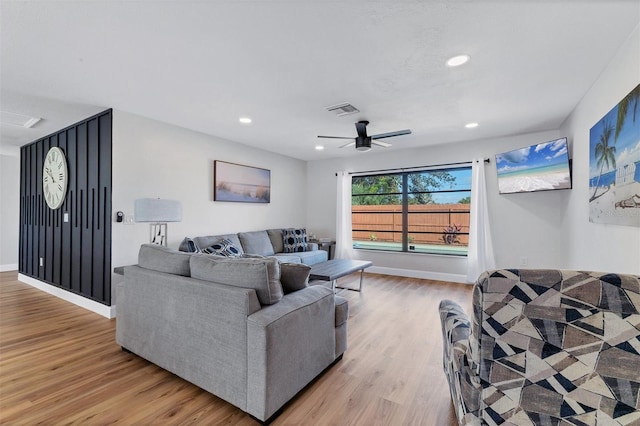 living room featuring ceiling fan and light hardwood / wood-style flooring