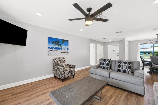 living room with hardwood / wood-style flooring and ceiling fan