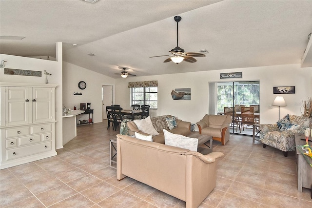 living room with light tile patterned flooring, vaulted ceiling, and ceiling fan