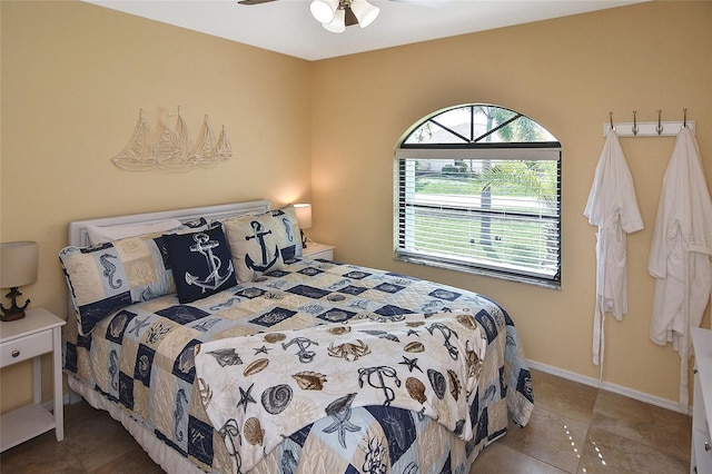 tiled bedroom featuring ceiling fan