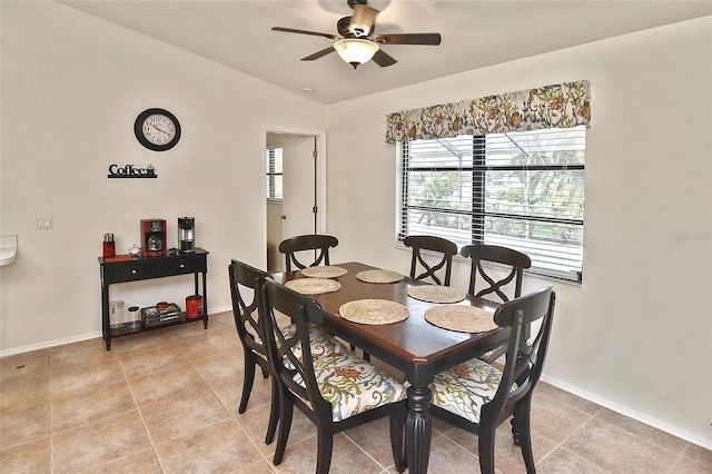 tiled dining room with lofted ceiling and ceiling fan