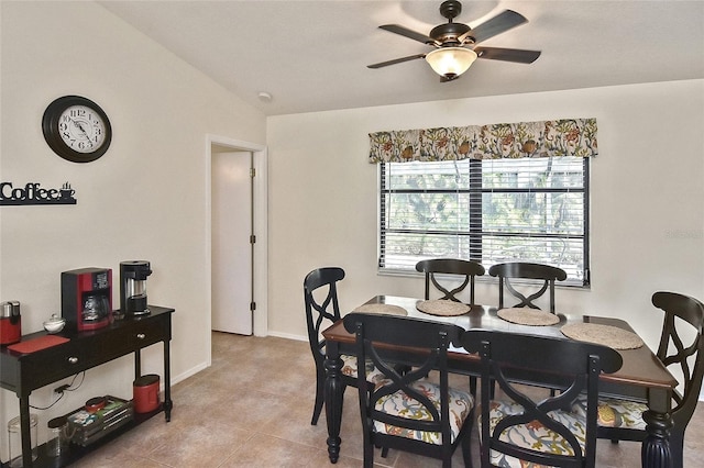 tiled dining room with vaulted ceiling and ceiling fan