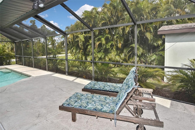 view of swimming pool with a patio area and a lanai