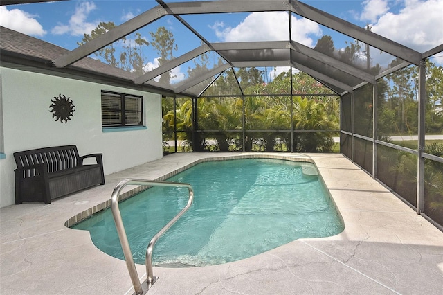 view of swimming pool featuring a patio and glass enclosure