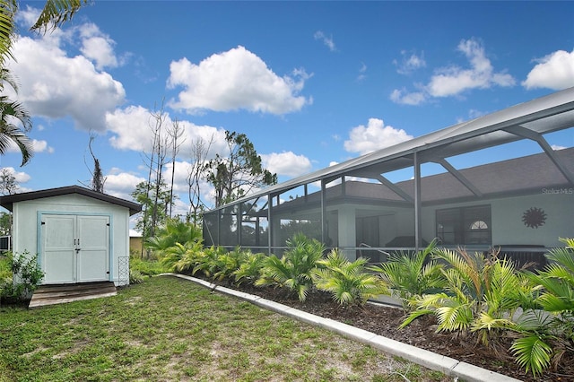 view of yard featuring glass enclosure and a storage shed