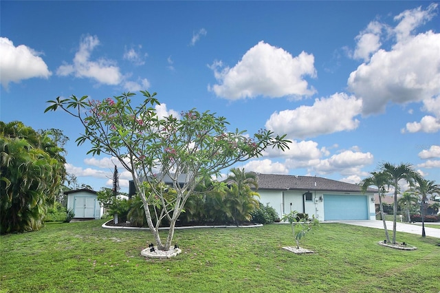 ranch-style house featuring a garage and a front lawn