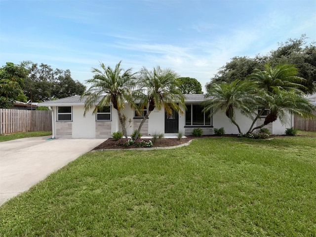 ranch-style home featuring a front yard