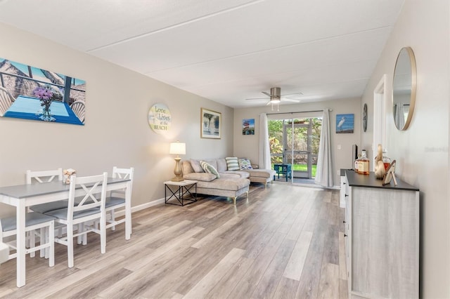 living room featuring ceiling fan and light wood-type flooring