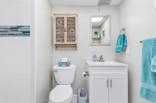 bathroom featuring toilet and vanity