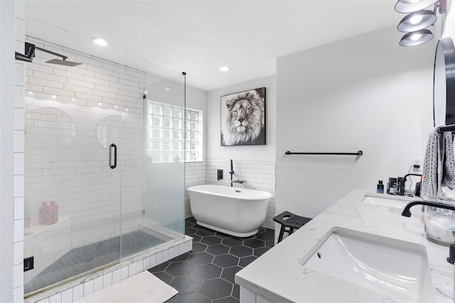 bathroom with vanity, tile walls, shower with separate bathtub, and tile patterned flooring