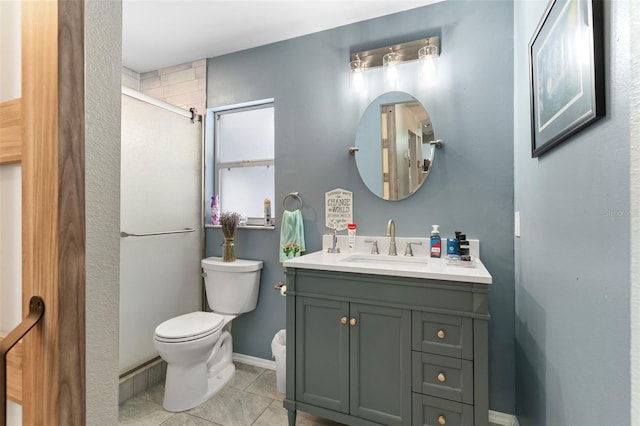 bathroom featuring vanity, tile patterned flooring, toilet, and walk in shower