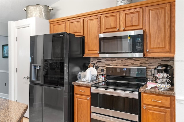 kitchen with appliances with stainless steel finishes and tasteful backsplash