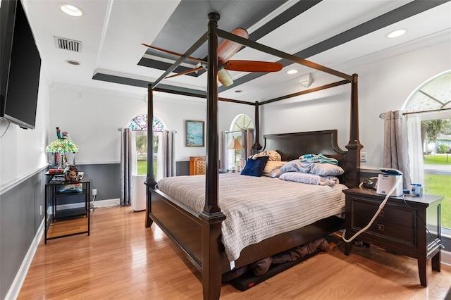 bedroom with ceiling fan, crown molding, and light hardwood / wood-style floors