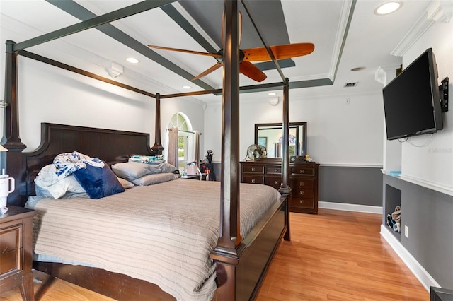 bedroom with crown molding and light wood-type flooring