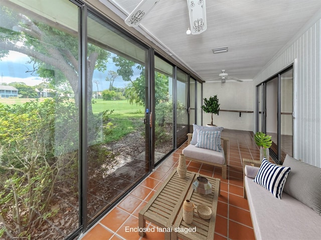 sunroom featuring ceiling fan