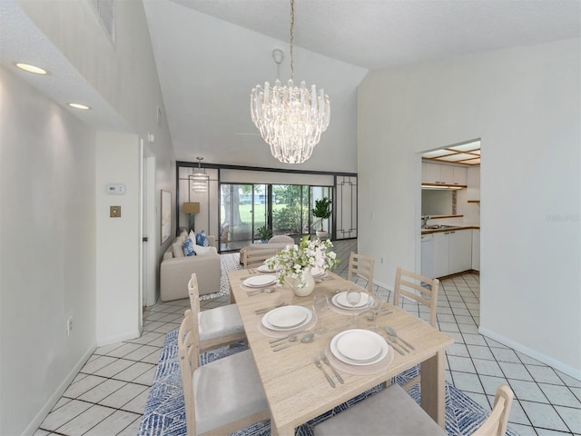 dining area featuring light tile patterned flooring, a chandelier, and high vaulted ceiling