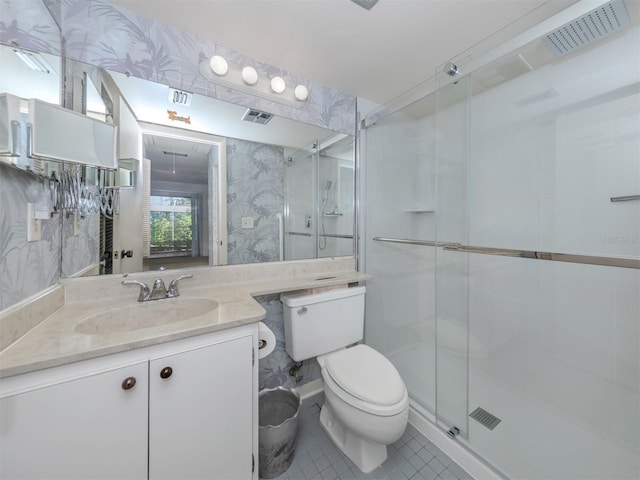 bathroom with walk in shower, tile patterned floors, toilet, and vanity