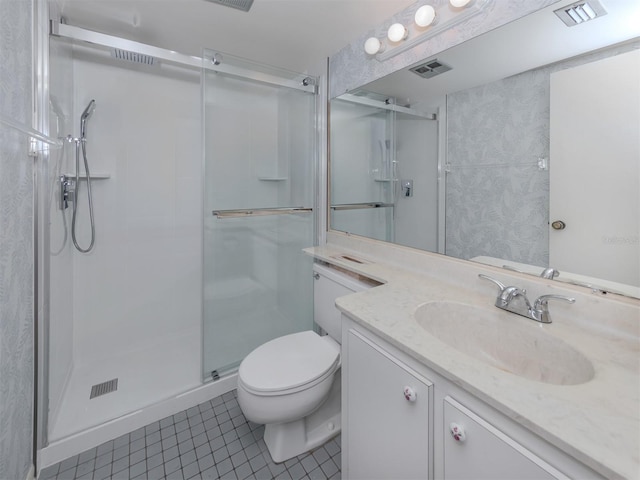 bathroom with vanity, walk in shower, toilet, and tile patterned floors