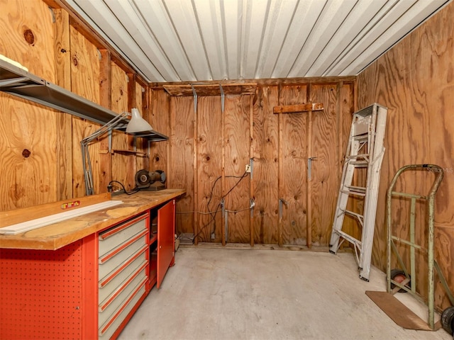 bar featuring wood walls and a workshop area