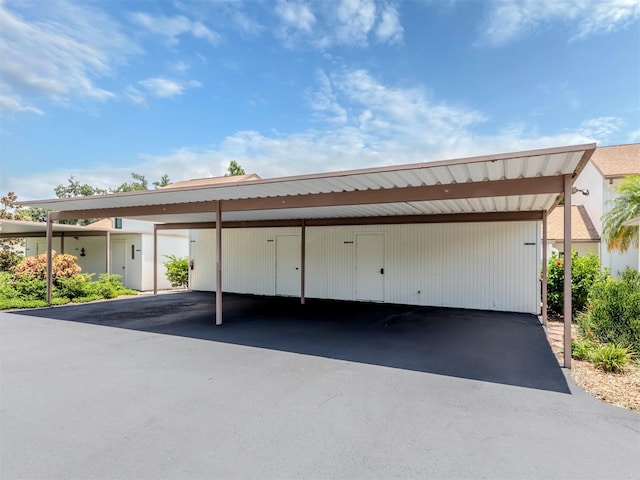 view of parking / parking lot featuring a carport