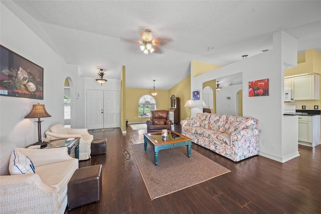 living room with lofted ceiling, ceiling fan, dark hardwood / wood-style flooring, and a textured ceiling