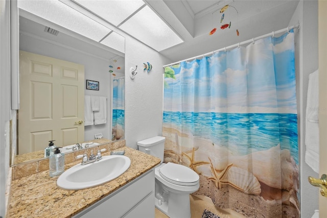 bathroom with toilet, vanity, and crown molding