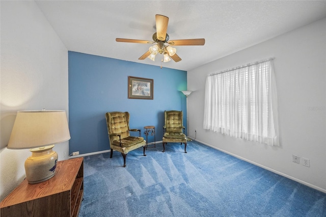 living area featuring ceiling fan and carpet flooring