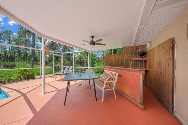 view of patio / terrace with ceiling fan and glass enclosure