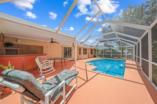 view of pool featuring a lanai, ceiling fan, and a patio area