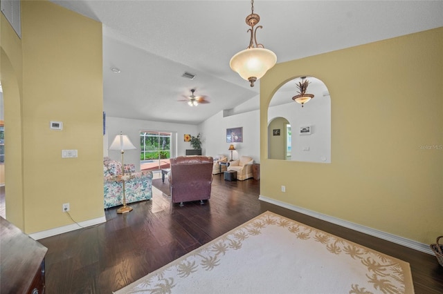 living room with vaulted ceiling, ceiling fan, and dark hardwood / wood-style flooring