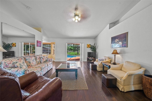 living room with dark hardwood / wood-style flooring and a textured ceiling