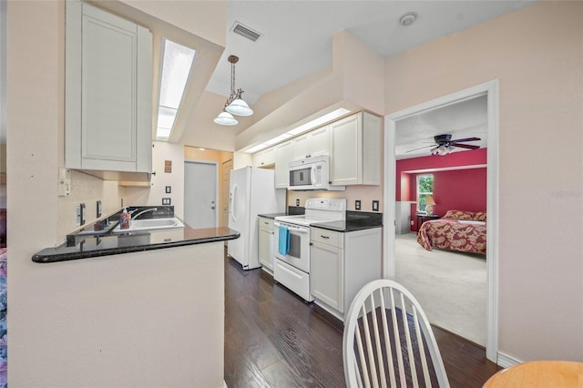 kitchen featuring white cabinetry, sink, white appliances, and pendant lighting