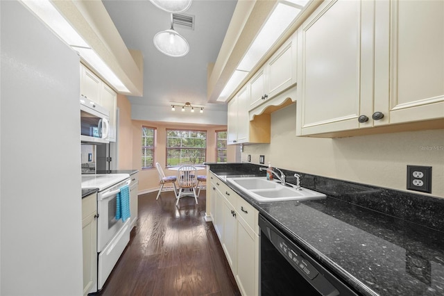 kitchen featuring dark hardwood / wood-style flooring, sink, white appliances, and dark stone countertops