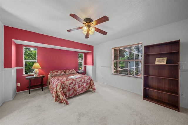 bedroom featuring ceiling fan and light carpet