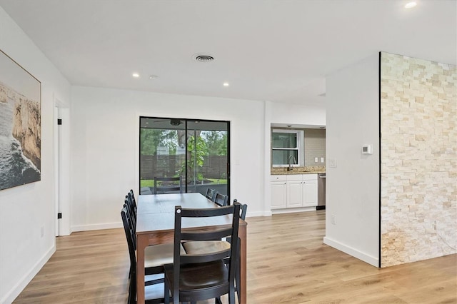 dining area with sink and light hardwood / wood-style flooring