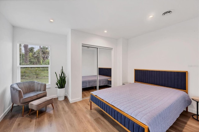 bedroom with a closet and light wood-type flooring