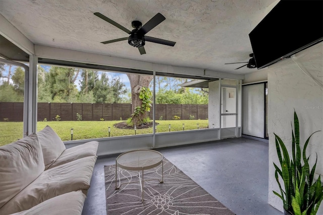 unfurnished sunroom with ceiling fan