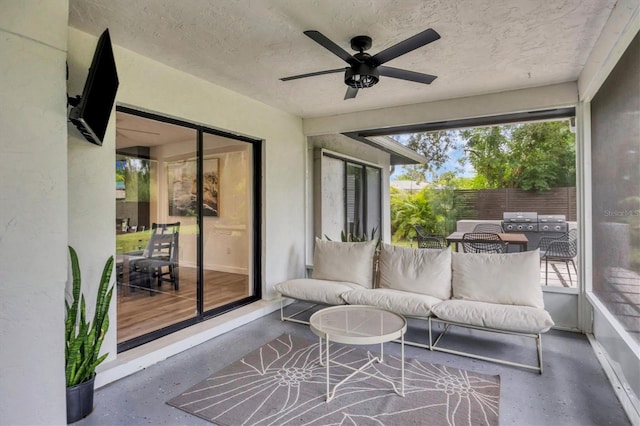 sunroom / solarium featuring ceiling fan