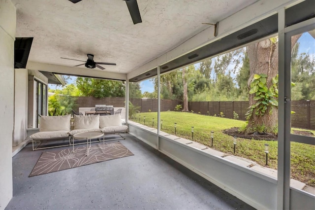 unfurnished sunroom with ceiling fan