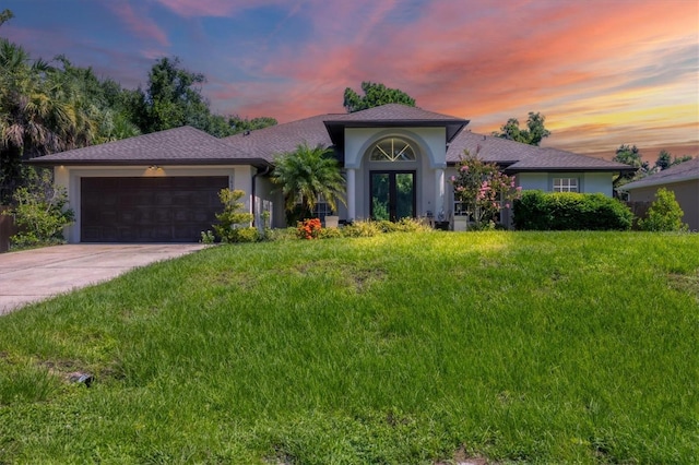 view of front facade featuring a garage and a lawn