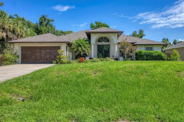 view of front of house with a garage and a front yard