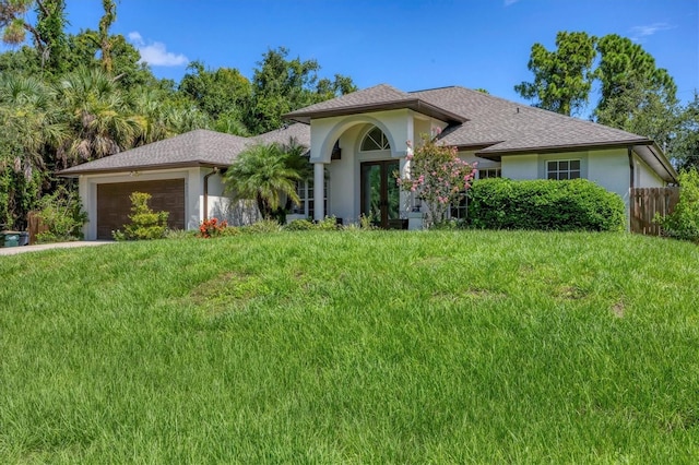 view of front of house featuring a garage and a front lawn