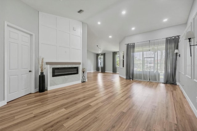 unfurnished living room featuring light hardwood / wood-style flooring and high vaulted ceiling