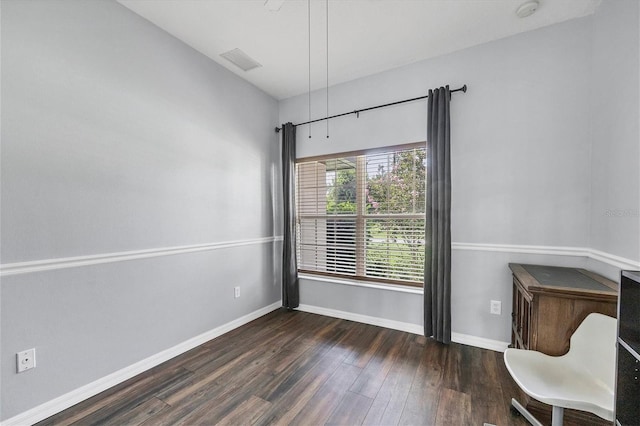 unfurnished room with dark hardwood / wood-style flooring