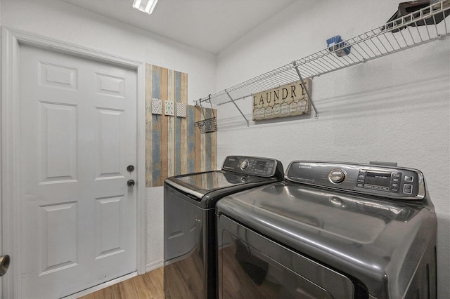 laundry room featuring hardwood / wood-style floors and separate washer and dryer