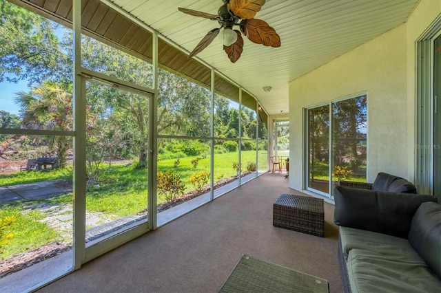 unfurnished sunroom with ceiling fan and vaulted ceiling